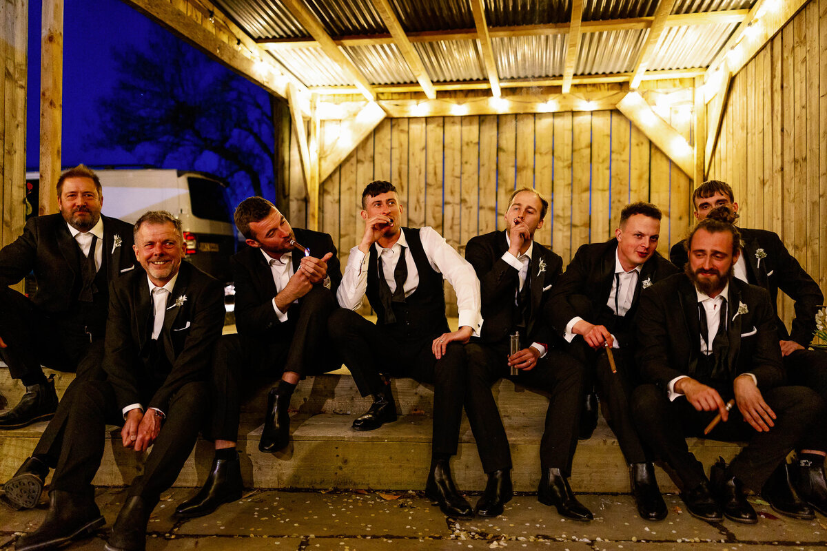 groomsmen sat together smoking cigars at Wharfedale Grange