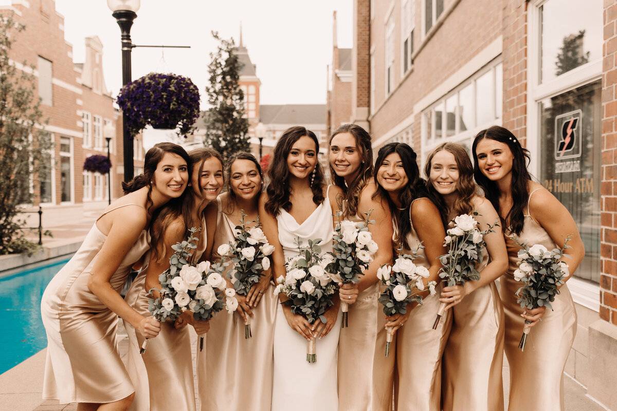 bridesmaids in neutral silk midi dresses at iowa wedding