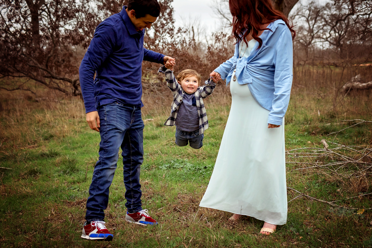 Capture winter family magic with our styled session near San Antonio. Laid-back parents, join our mom-to-be in her scarlet flying dress for a memorable and upscale photography experience.