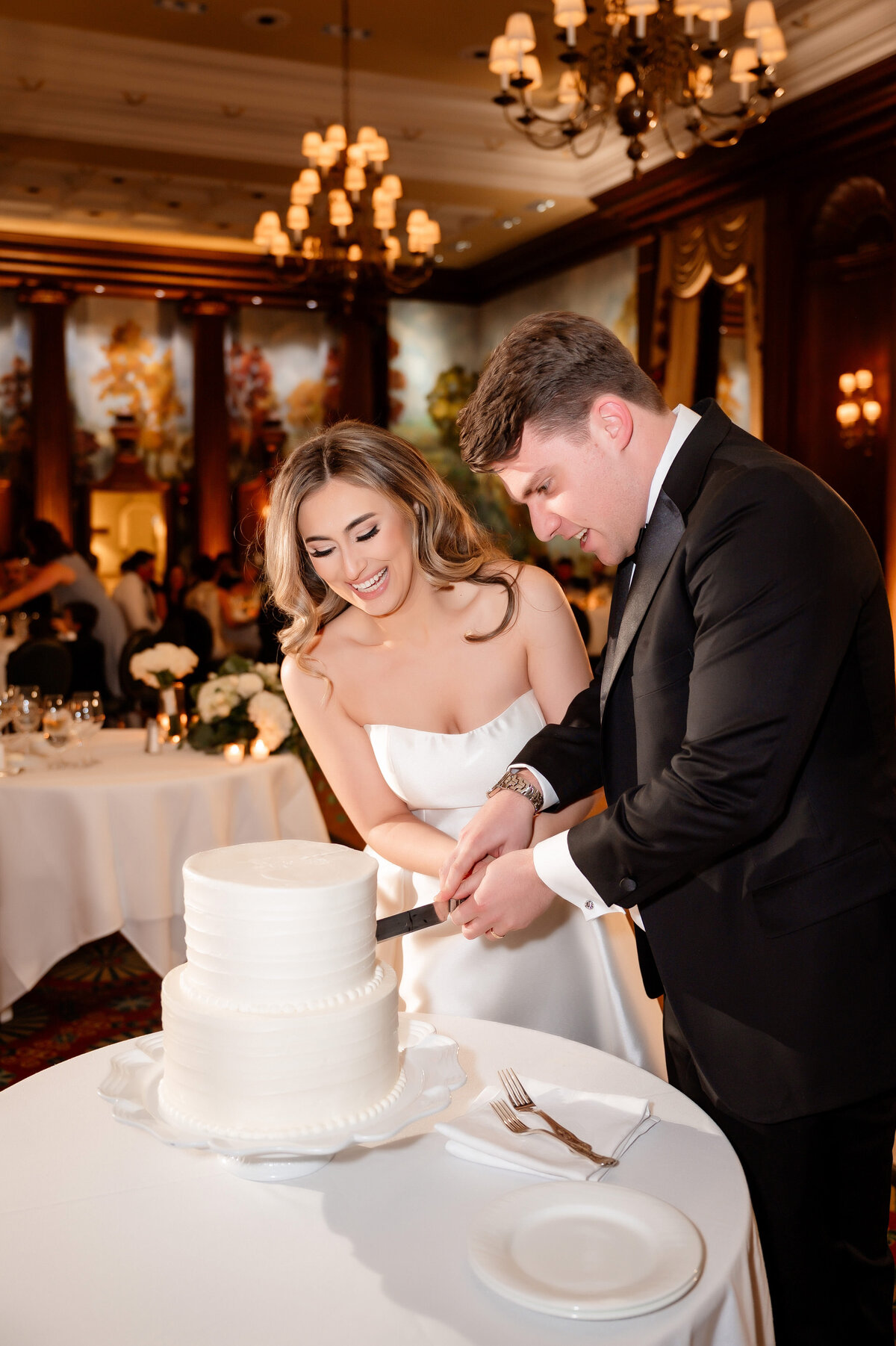 cutting cake at their wedding in duquesne club ballroom