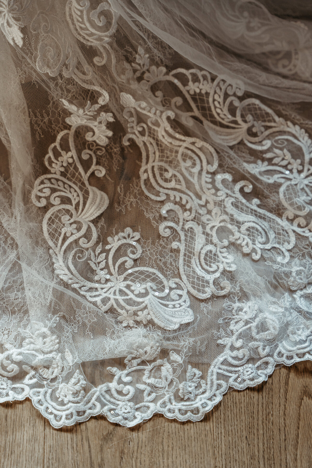 Close-up of bride’s wedding dress lace details