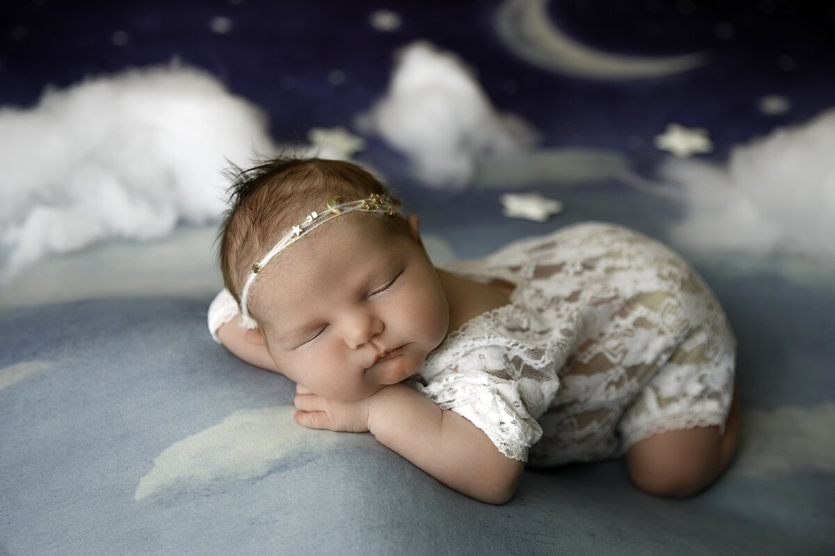 Portrait of a Sleeping newborn baby on cloud blanket and background