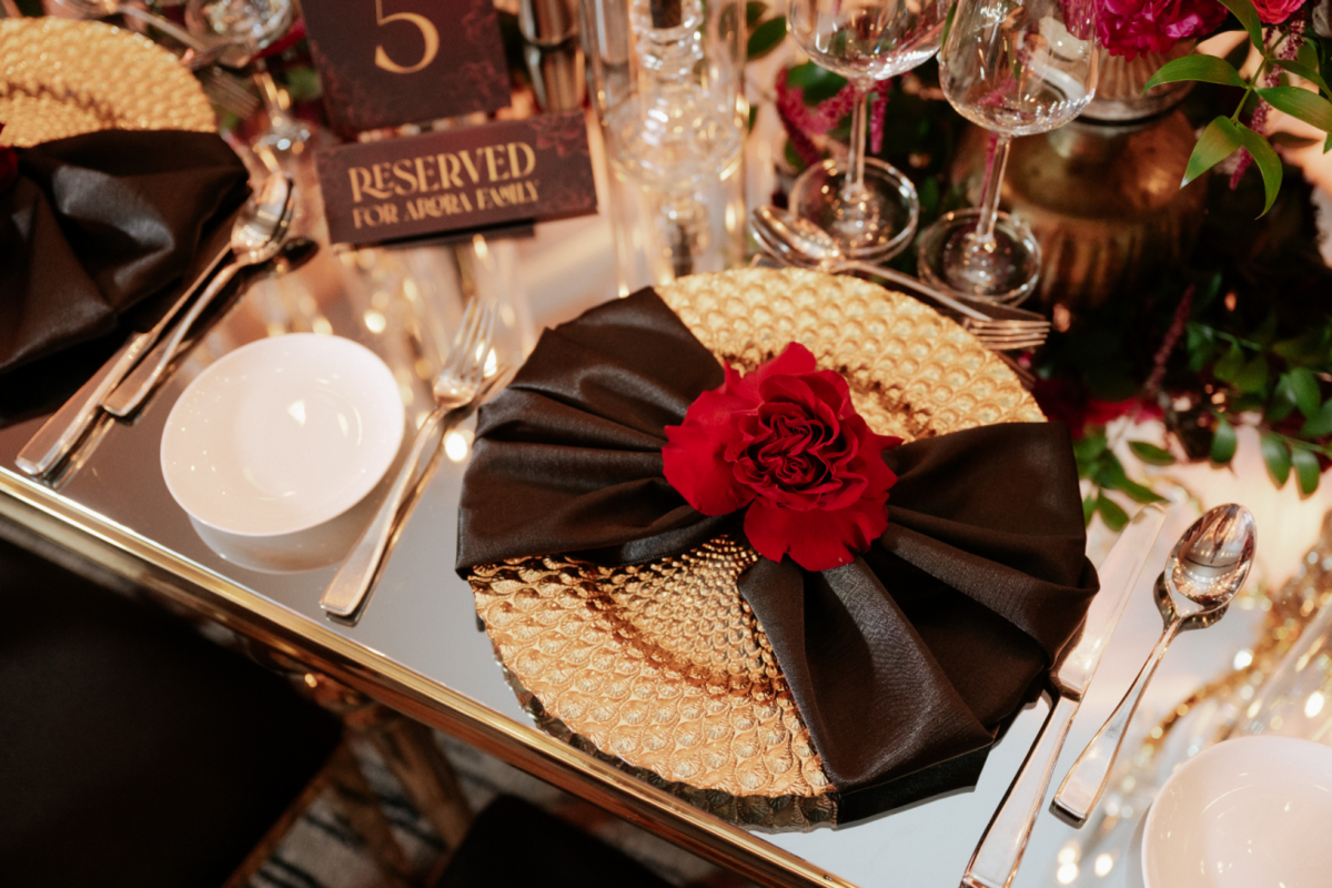 black-gold-pink-burgundy-wedding-reception-peacock-charger-bowtie-napkin-red-rose