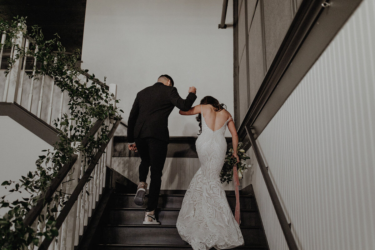 Newly married couple walking at the stairs at The Evergreen Events Place in Portland, Oregon