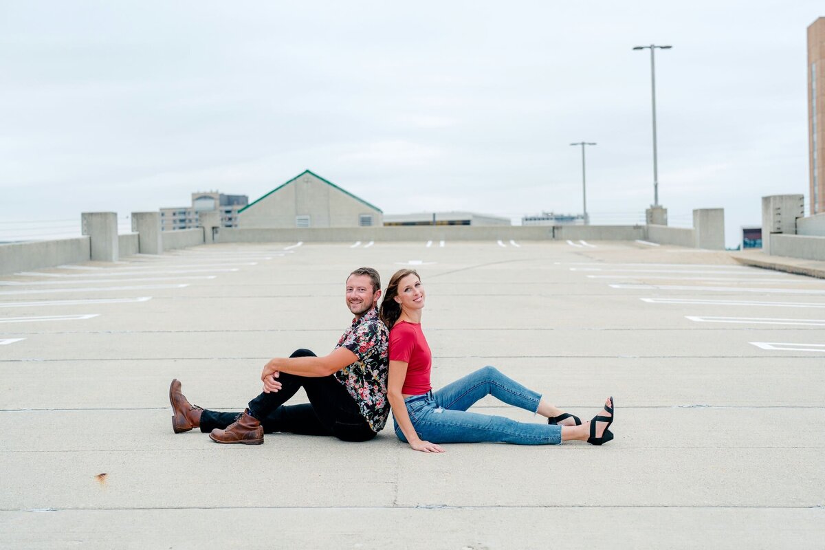 couple-sitting-back-to-back-urban-engagement