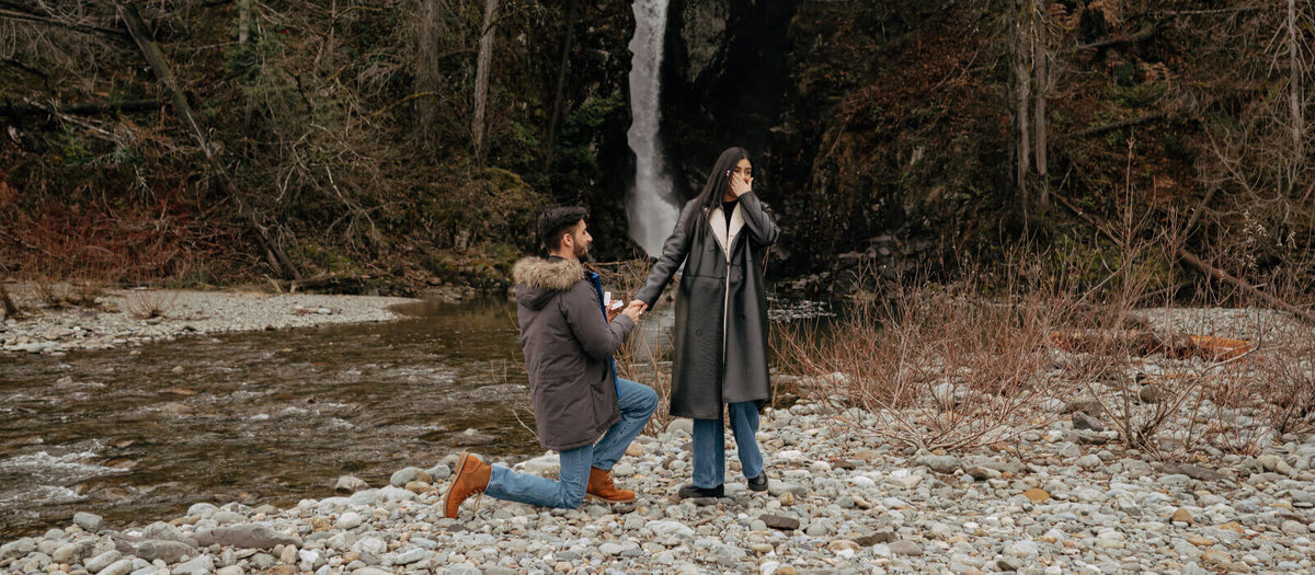 Outdoor proposal photoshoot by a waterfall