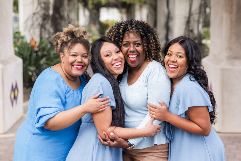 mother and daughters laughing and hugging