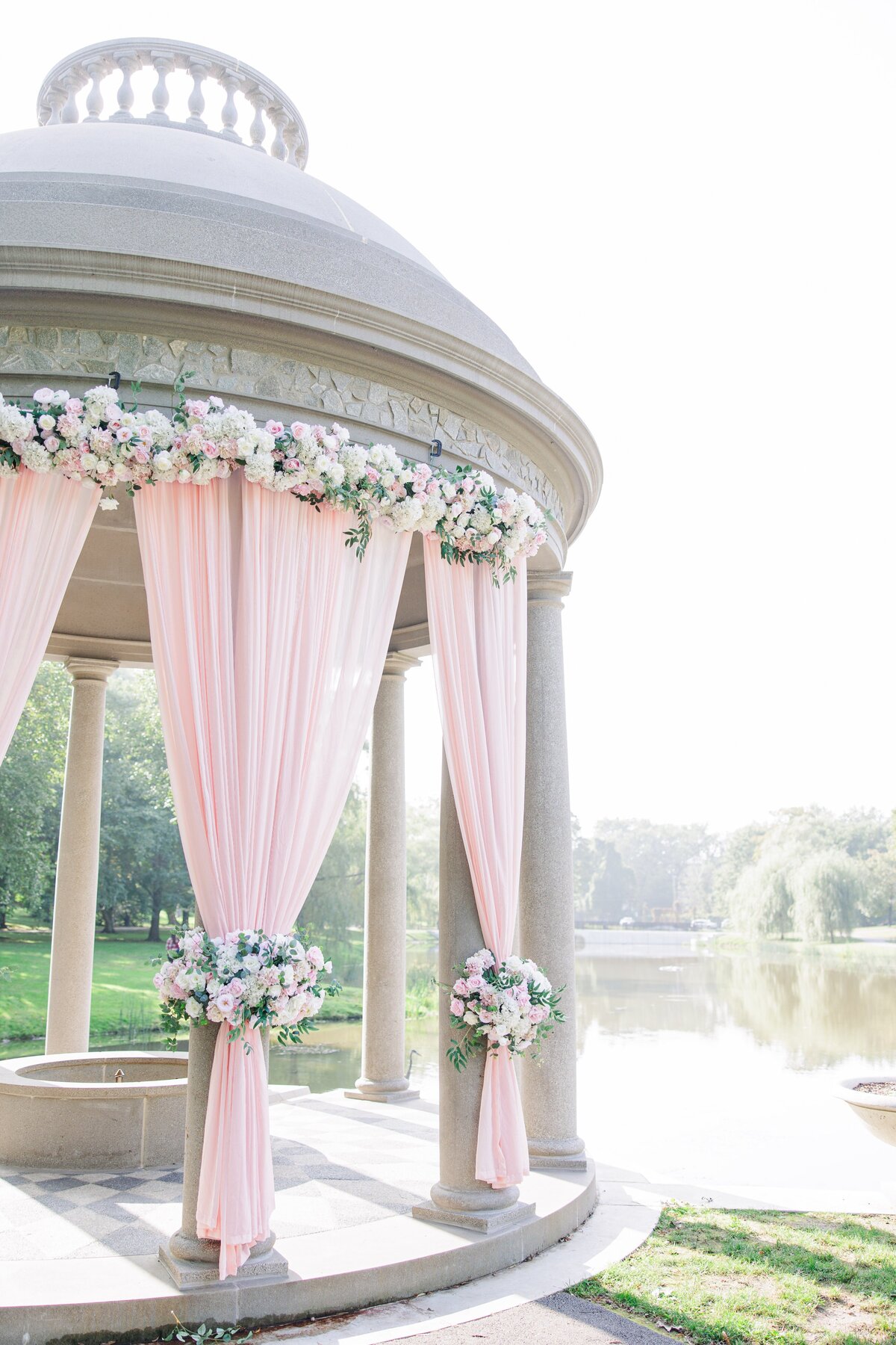 Larz Anderson Park tempietto with wedding florals and blush draping
