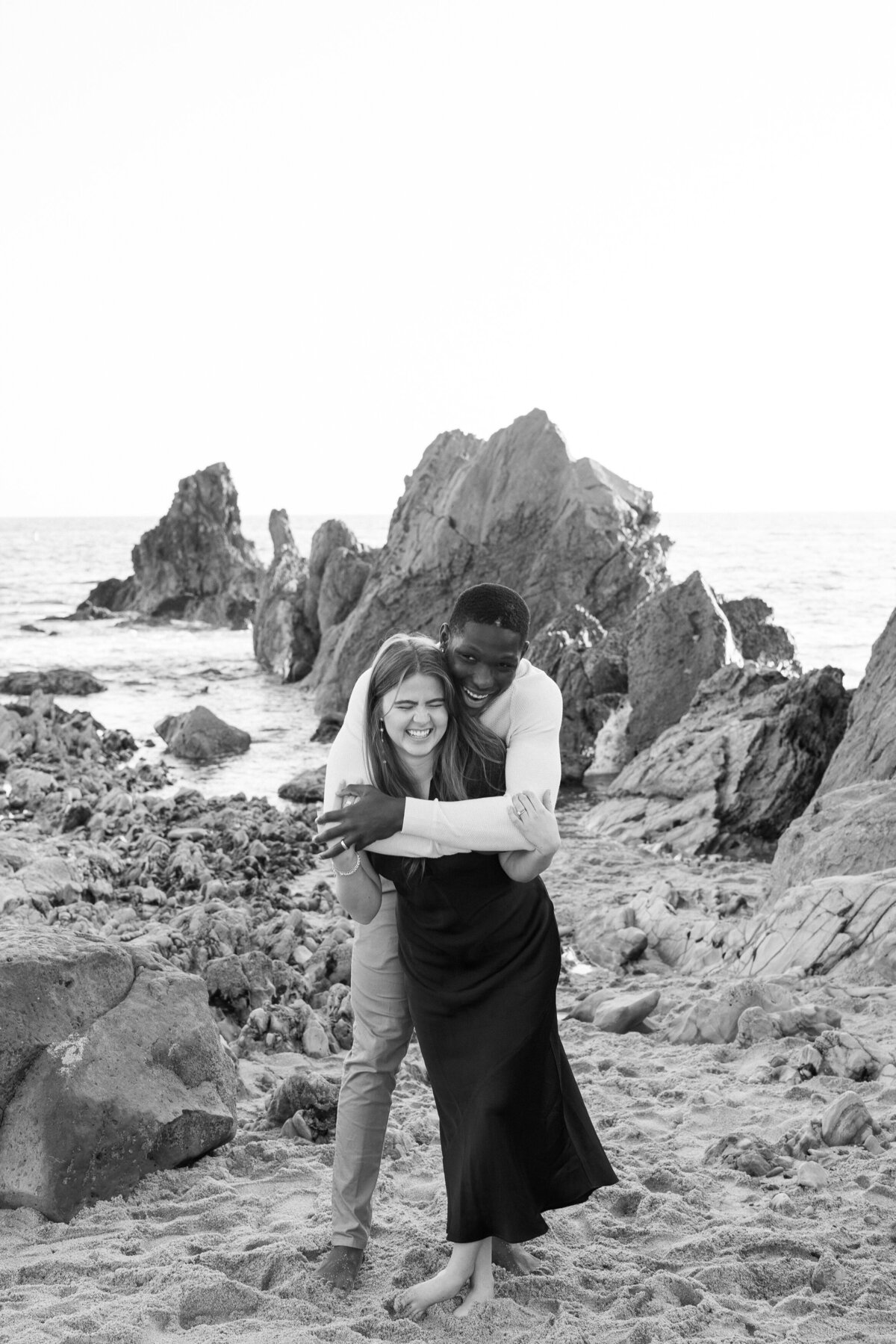 black and white photo of a couple on the beach