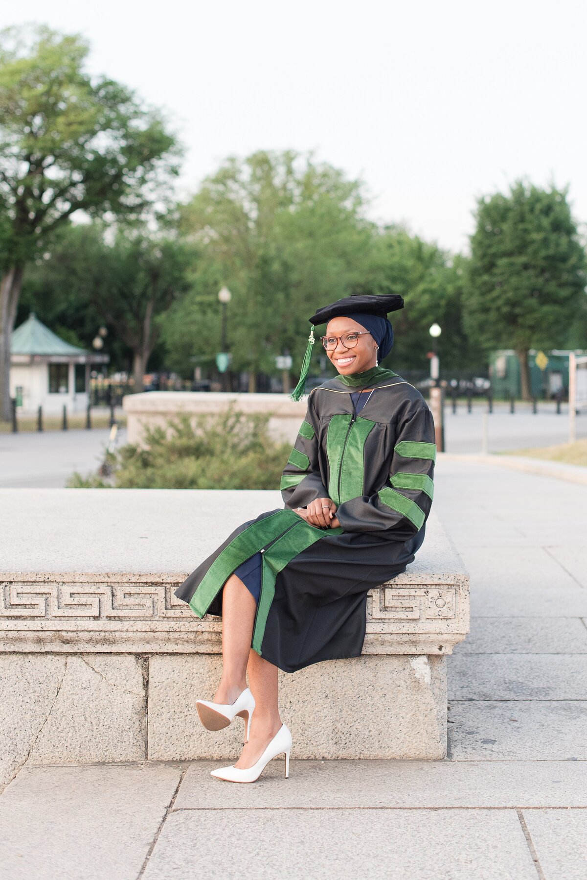 girl in regalia for med school green black