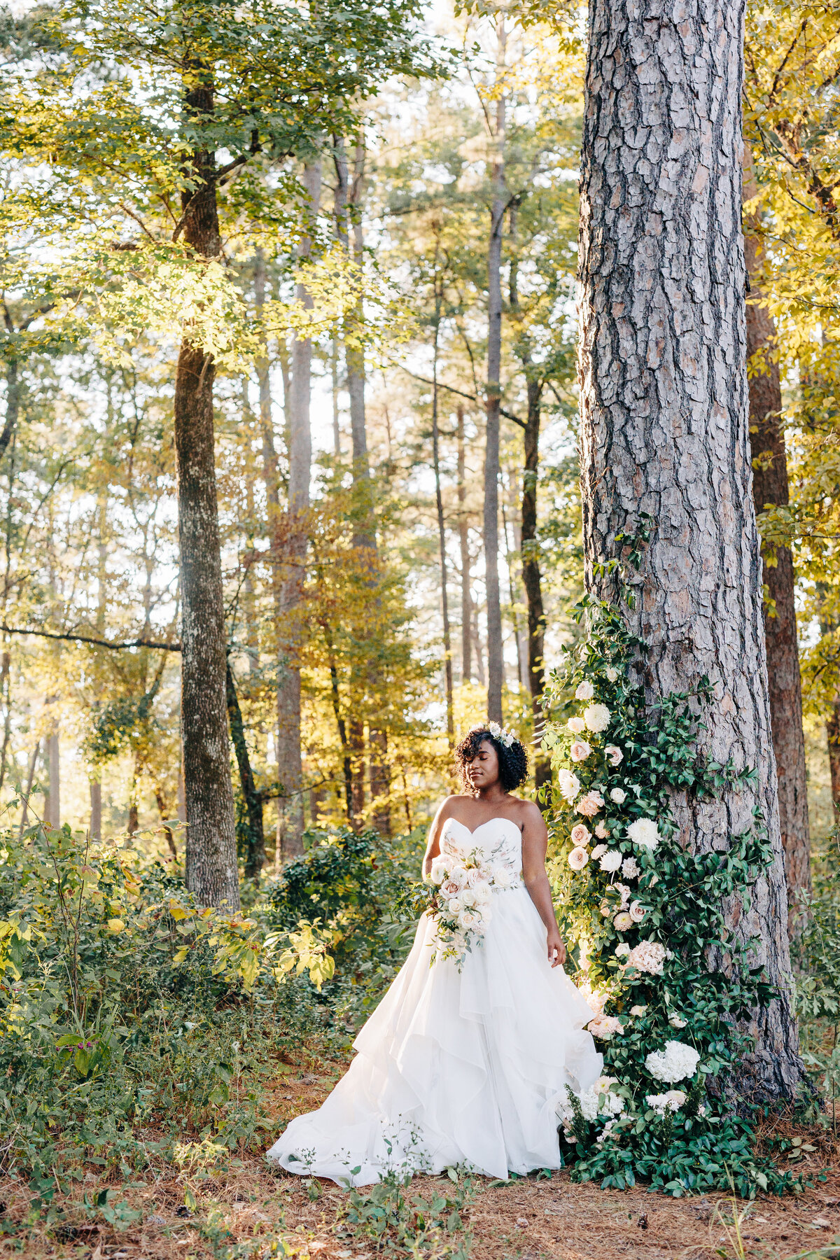 bride in a wedding photo while standing in a beautiful forest