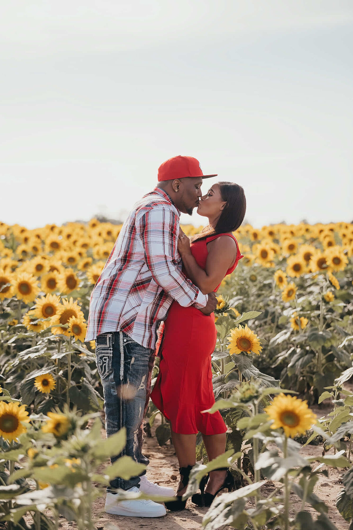 engagement session in a field of flowers