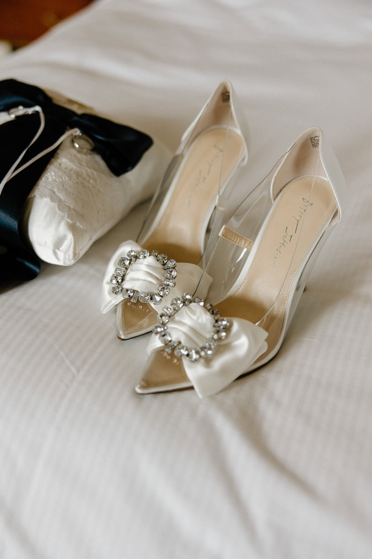 A close up of the heels and bag the bride will use at her wedding