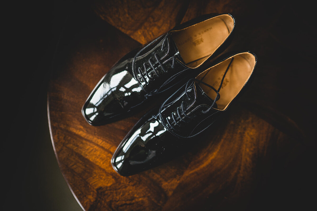 A detailed photograph of the grooms shoes