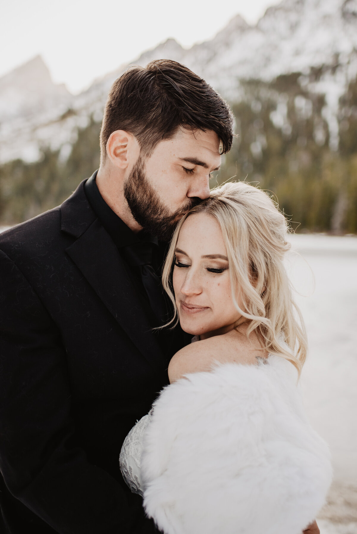 Jackson Hole Photographers capture couple snuggling during winter elopement photos