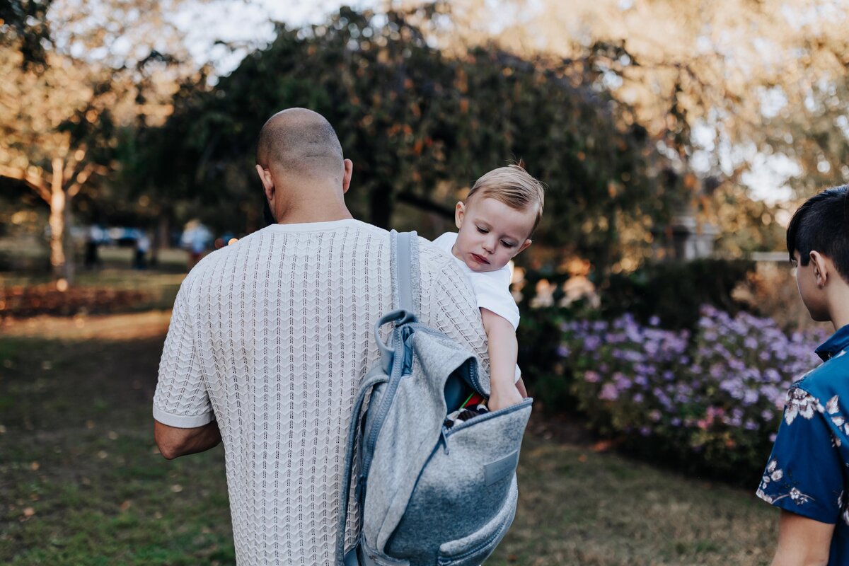 Nashville family photographers capture father holding baby and diaper bag