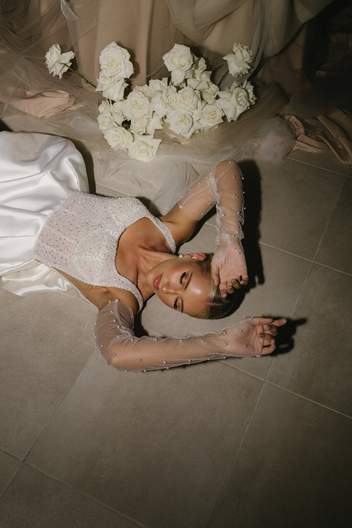A glamorous bride in her wedding reception dress with luxury soft glam makeup in Cairns.