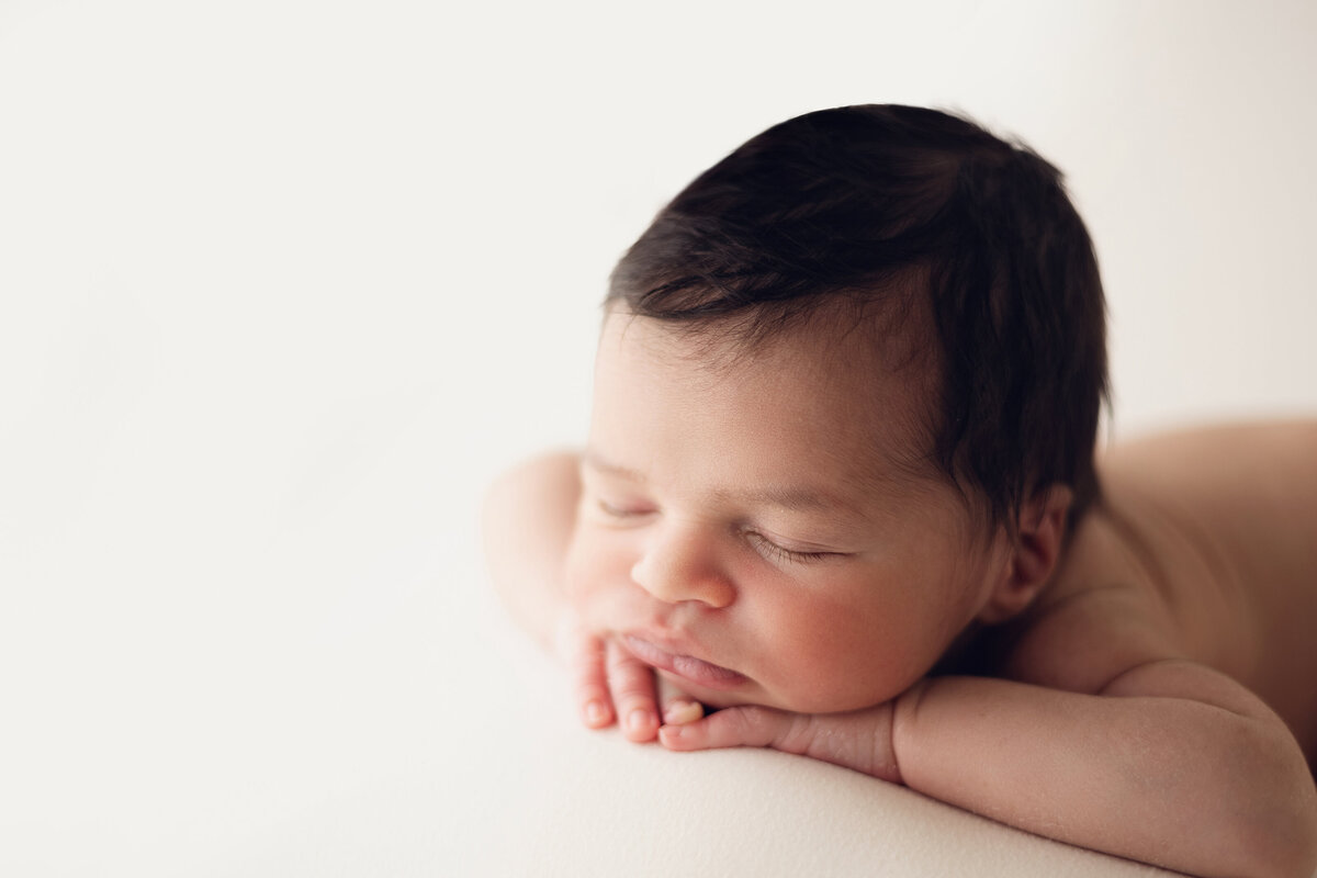 baby with dark hair sleeping