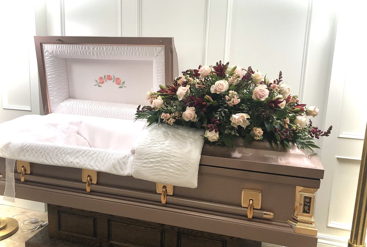 pink-and-burgandy-funeral-casket-piece-at-white-pine-funeal-home-arrangment
