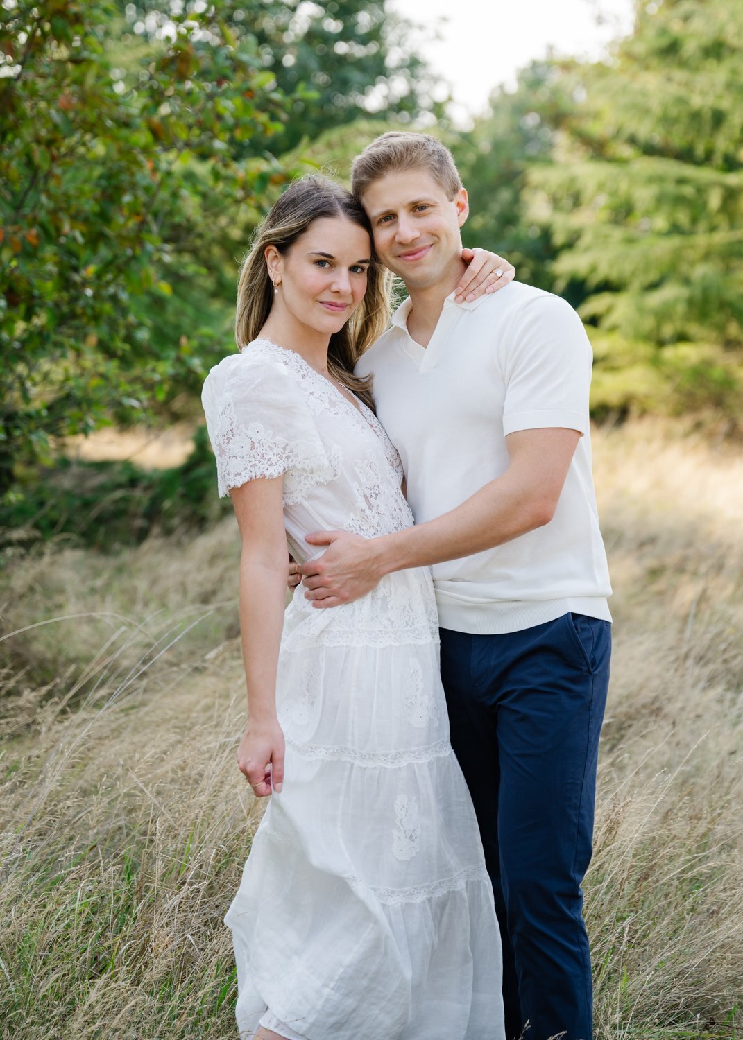 engaged couple hug in seattle field for engagement photo