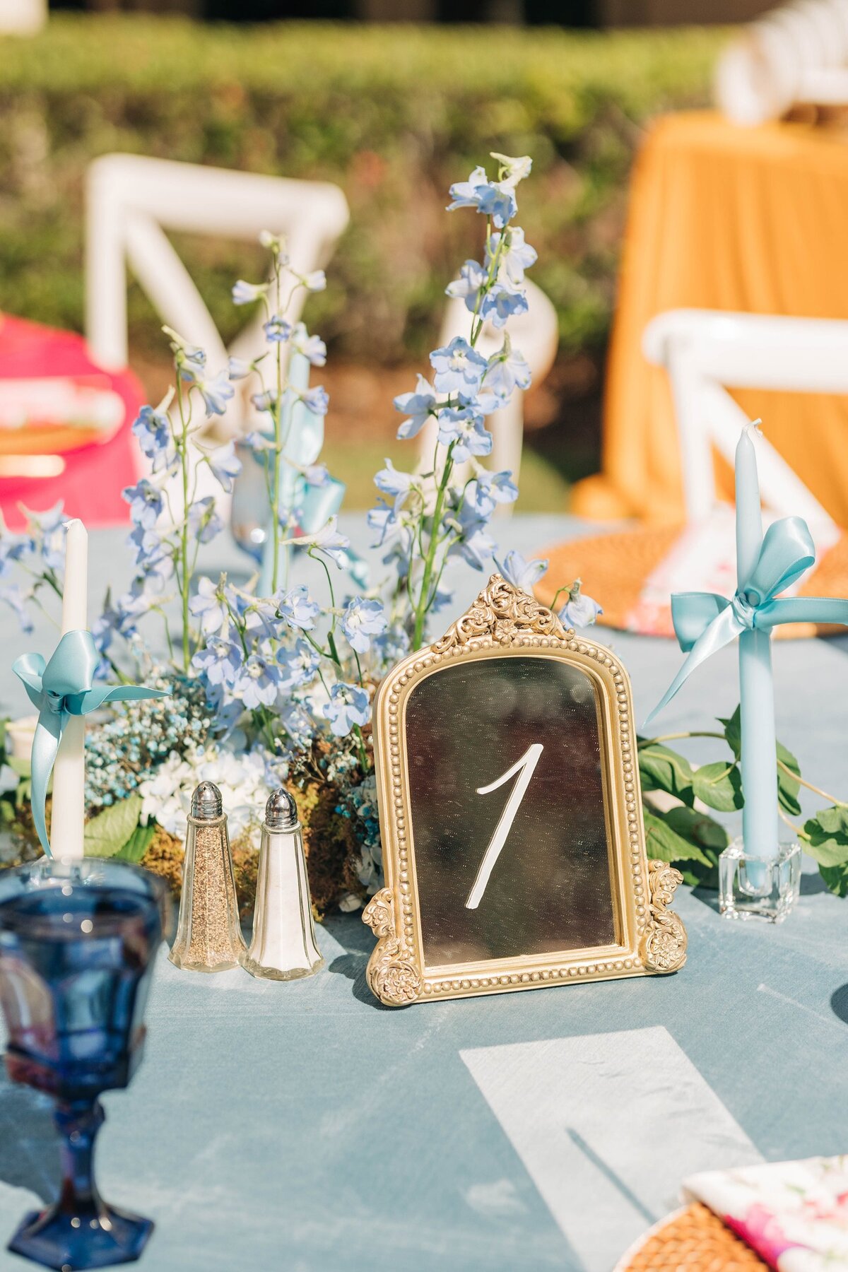 5x7 and 8x10 gold mirrors with ornate decor on the top and calligraphy for table number