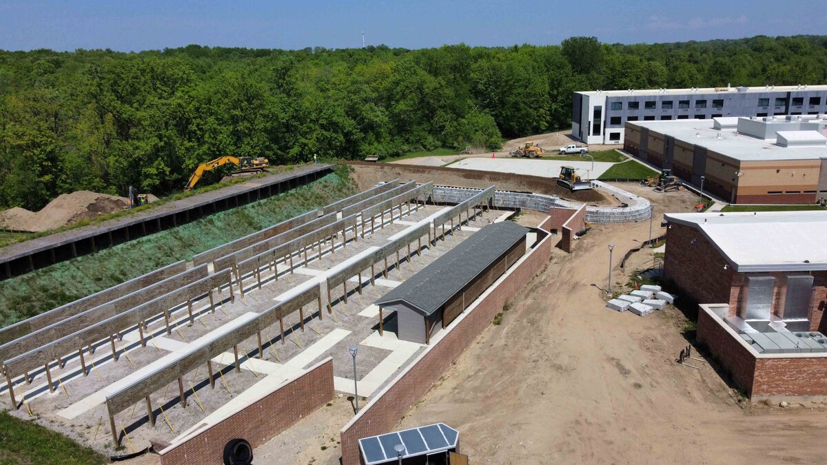 redi-rock-retaining-wall-placement-michigan-correctional-facility-highland-services-drone-image