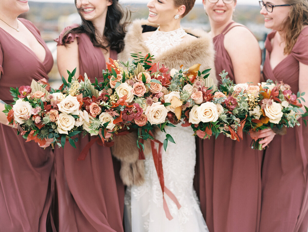 Bridesmaids laughing and holding flowers photographed by Chicago editorial wedding photographer Arielle Peters