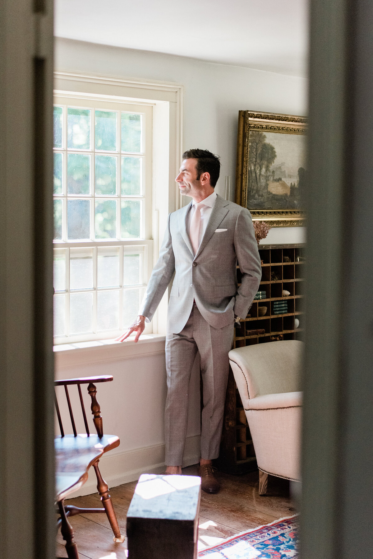 Husband thinking to himself while looking outside a window 