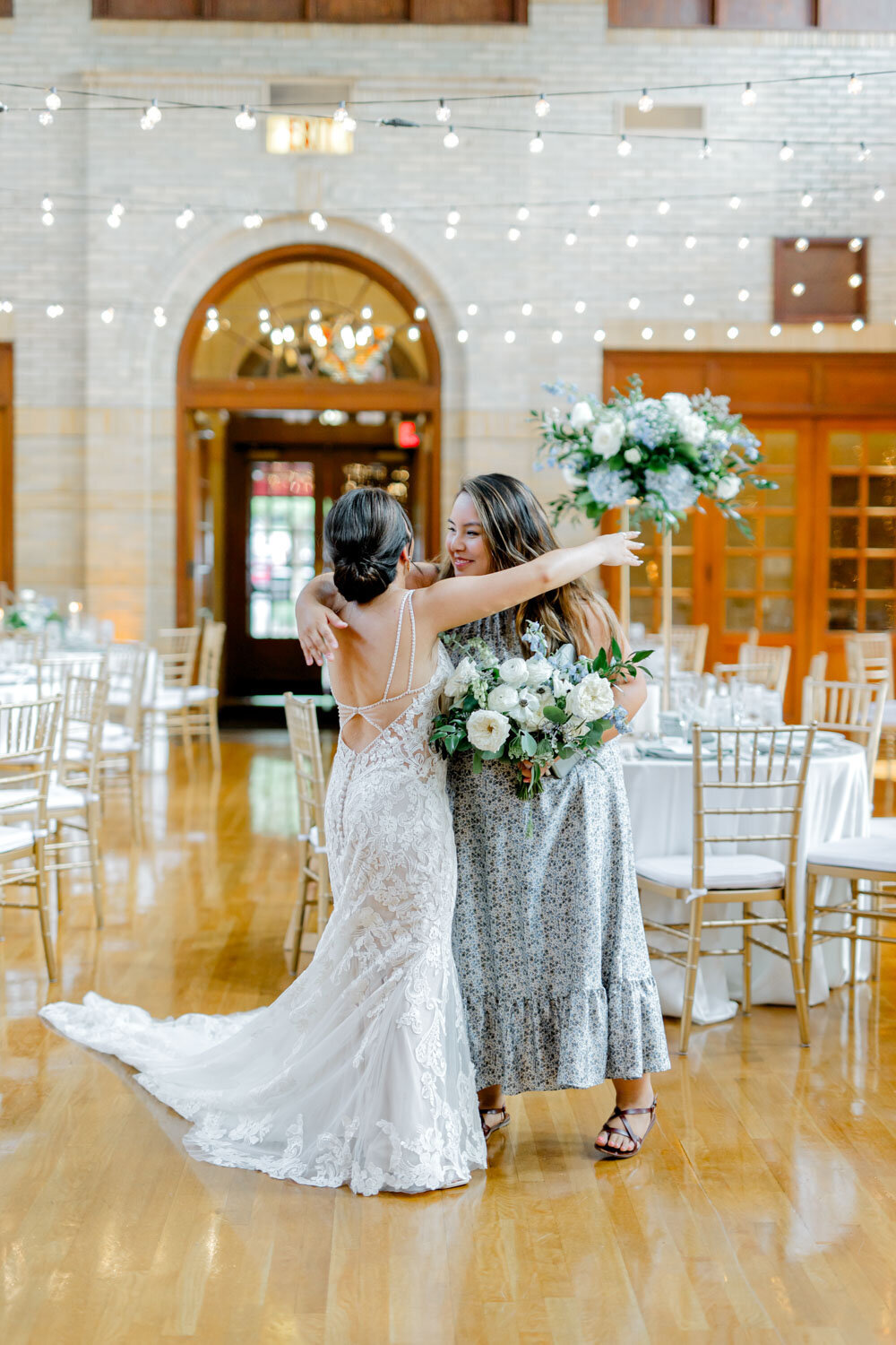 Bride hugging a guest in the reception hall