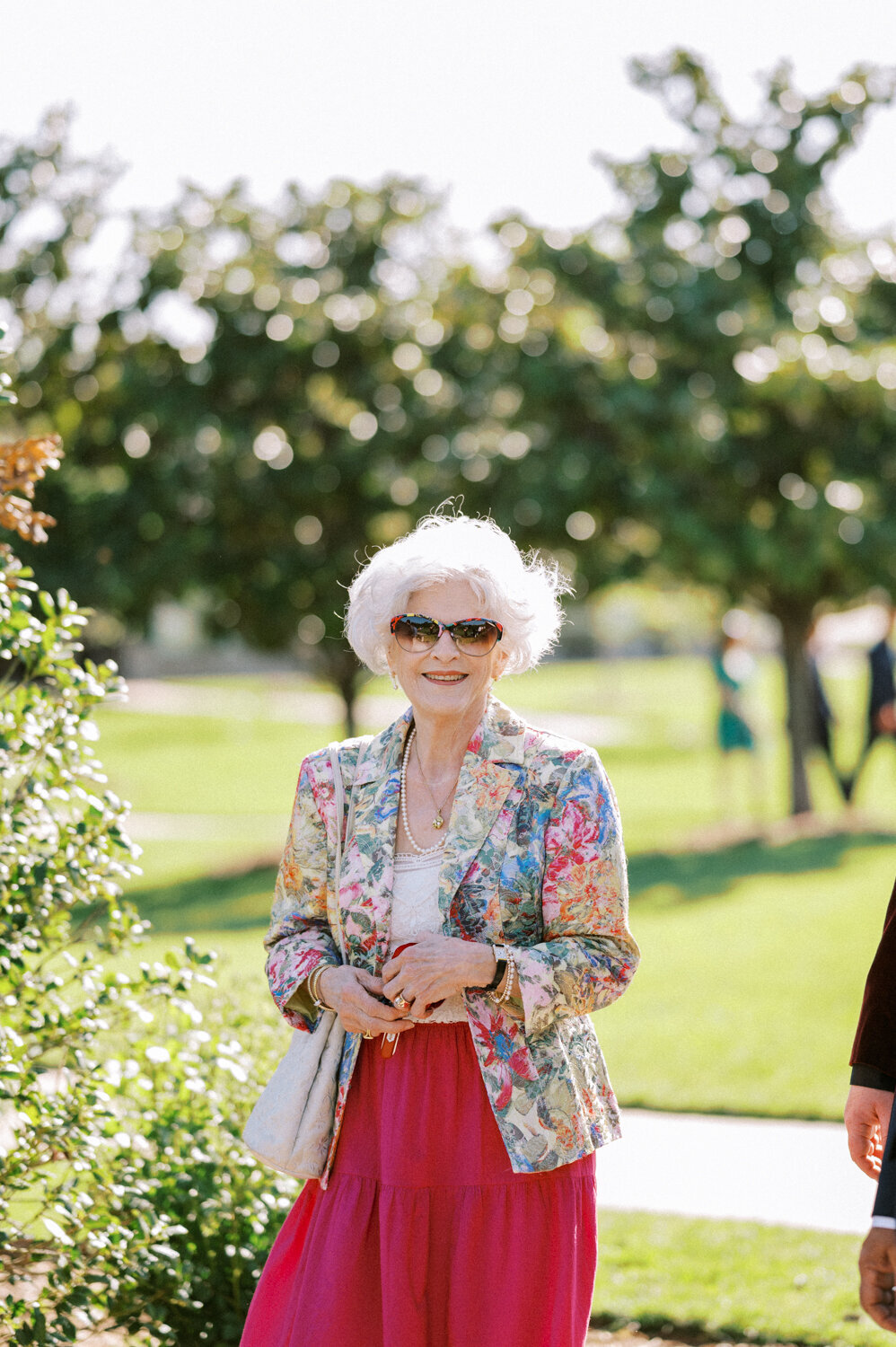 chic-woman-walking-into-garden-ceremony