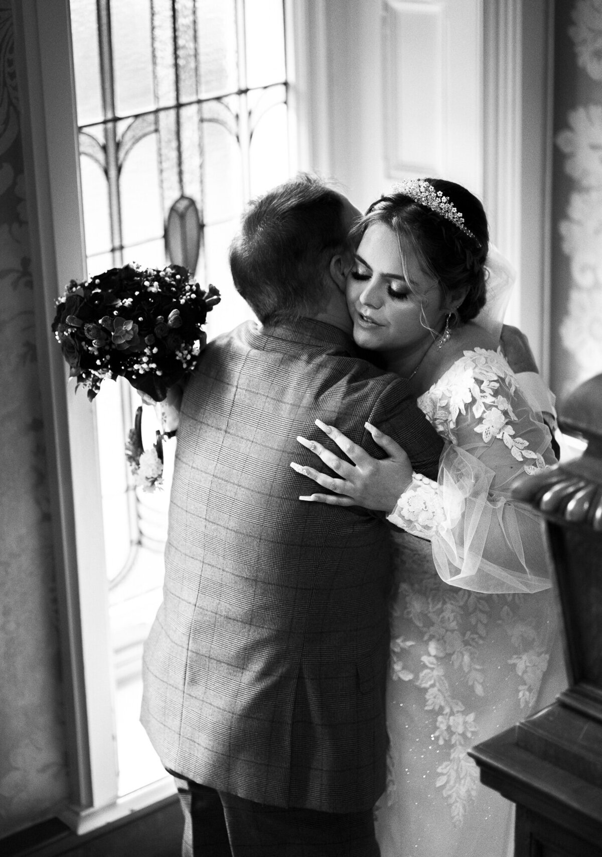 Bride hugging father at Merewood Country House Hotel taken byt candid wedding photographer Anthony Horseman