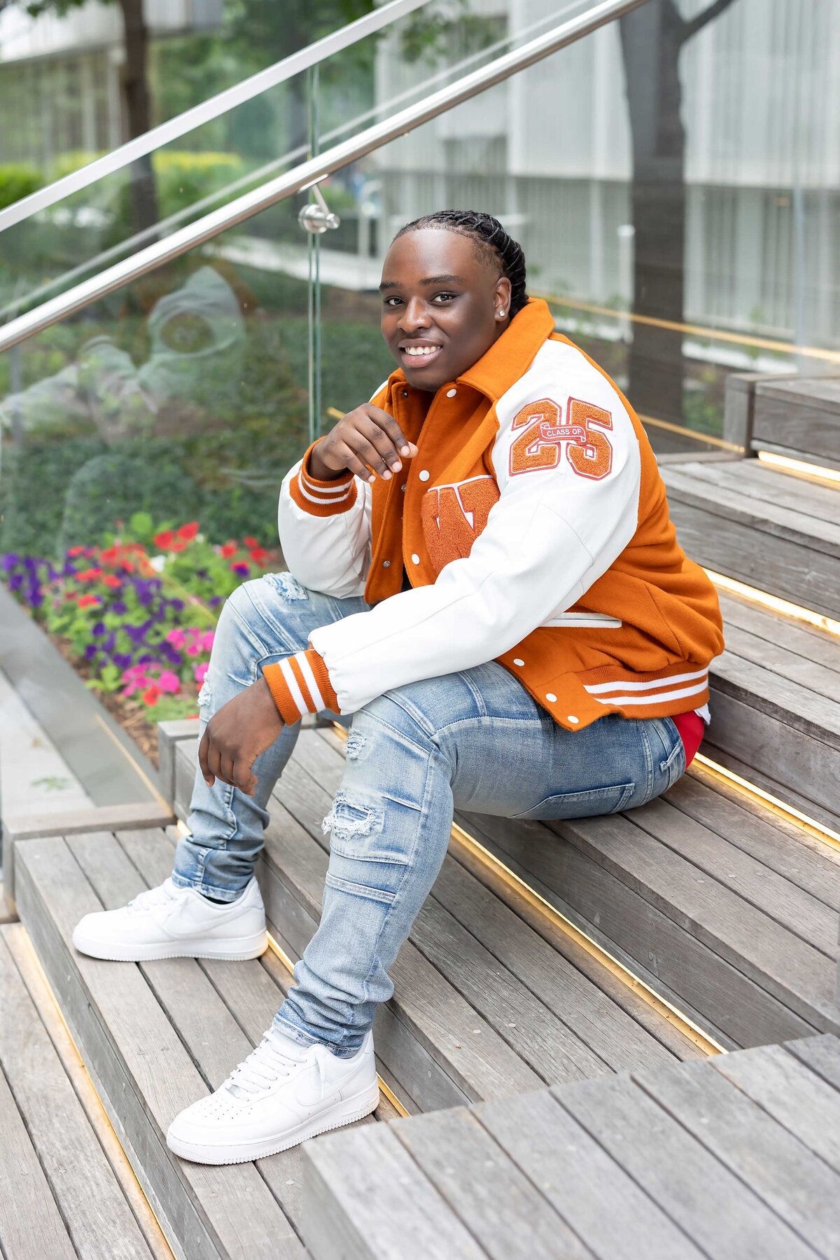 High school senior photo of a young man wearing his senior year jacket, featured in a professional Senior Photography Portfolio.