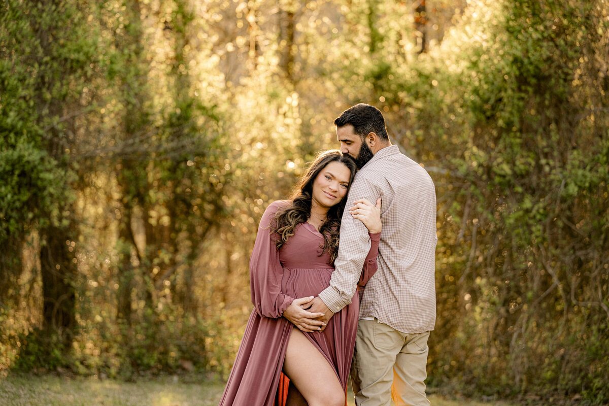 couple maternity session with my in a rose colored dress and dad  browns in a waxhaw nc park