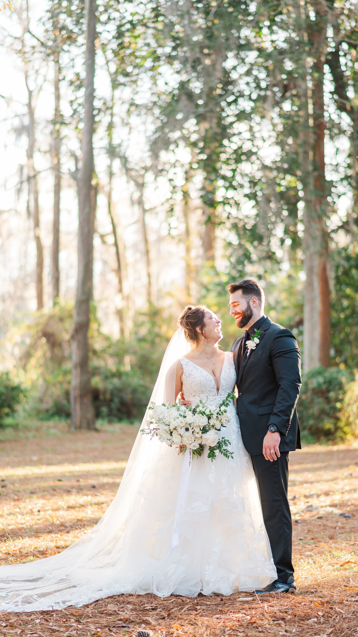 couple smiling at greenfield lake park during their wedding photos