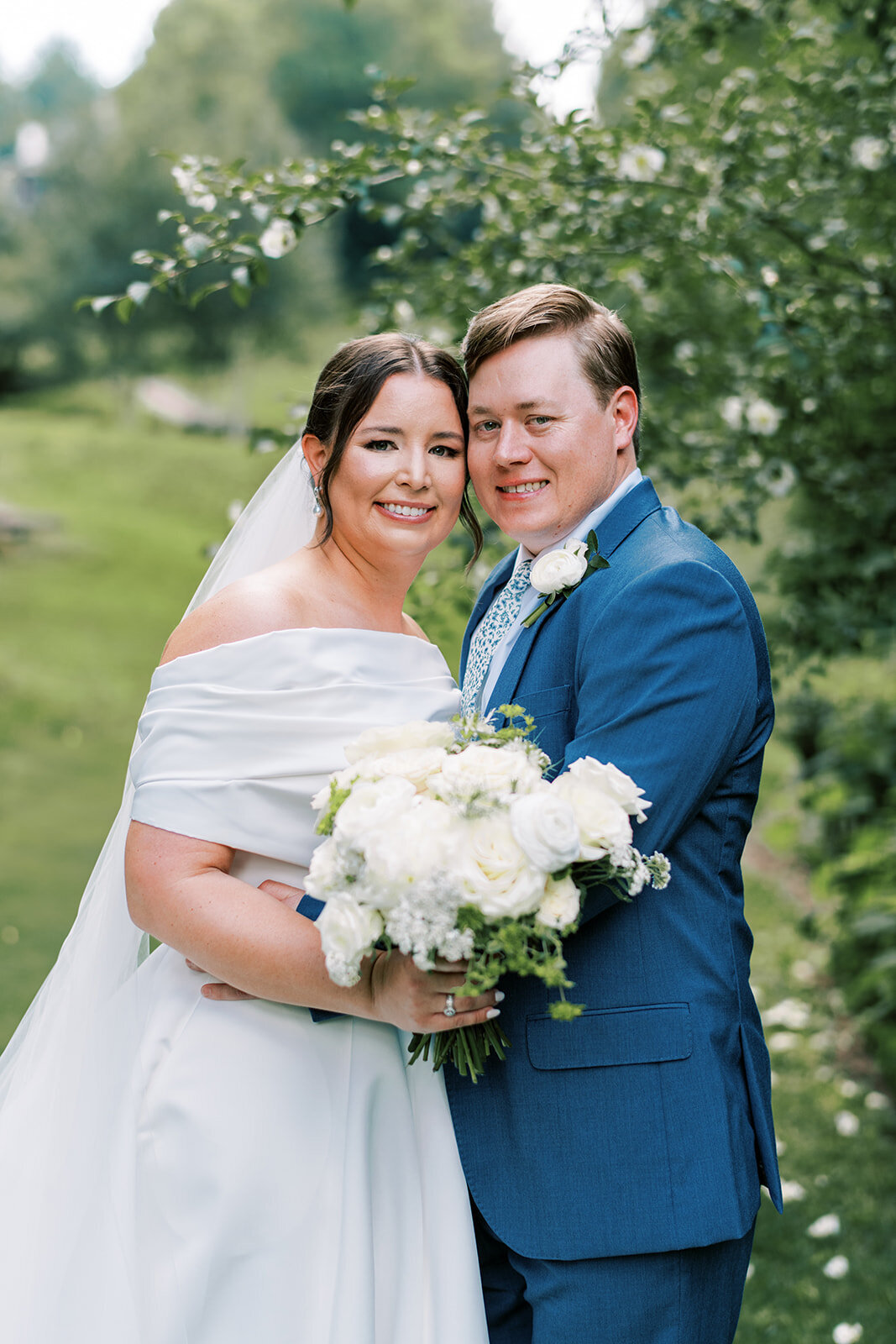 Classic outdoor wedding portrait of bride and groom surrounded by lush greenery in Cashiers North Carolina