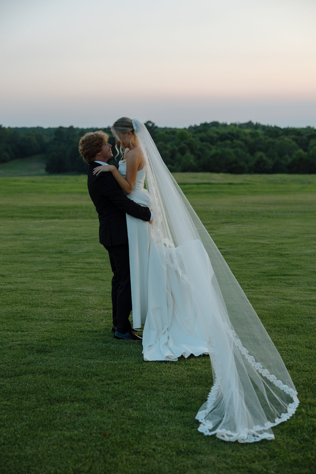 Groom lifts the bride
