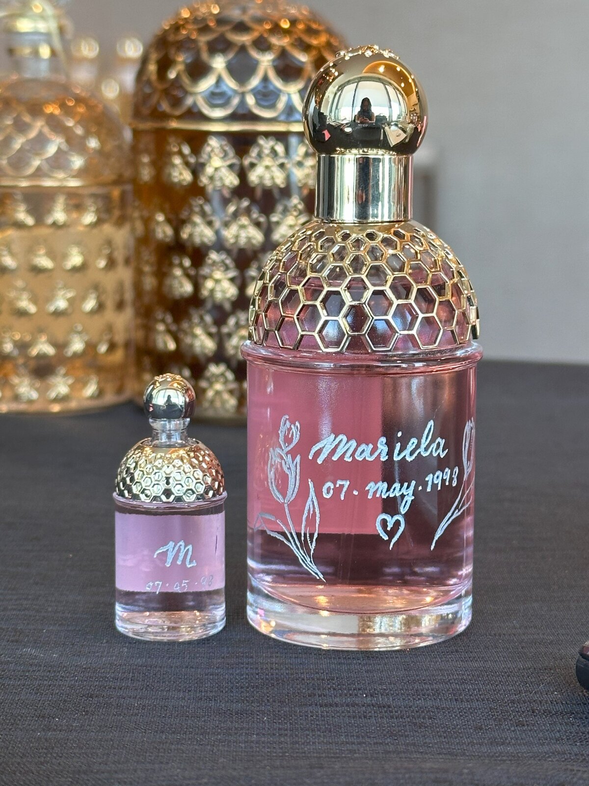 Personalized Guerlain perfume with floral and initial engraving, bespoke luxury gift. Live engraved on site by Toronto event artist Jenny Zhang