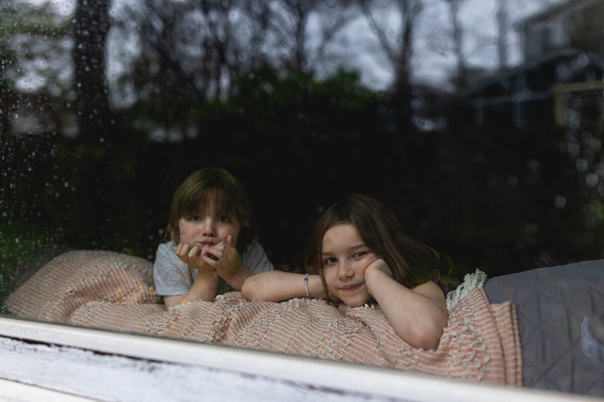 Two children looking out the window