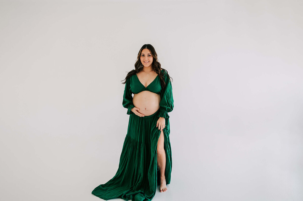 maternity photo in Branson MO of pregnant mom smiling in studio