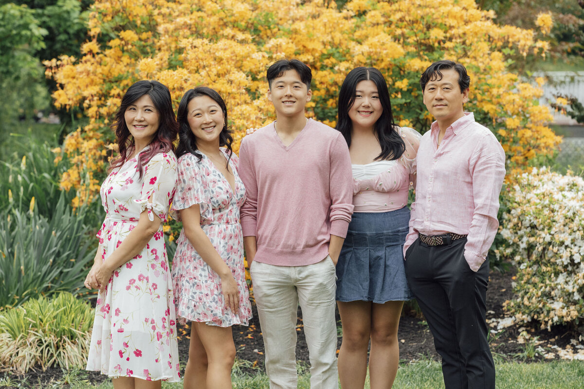 Family Photographer | Family posing together surrounded by vibrant summer flowers at Sayen Gardens | Hamilton, New Jersey