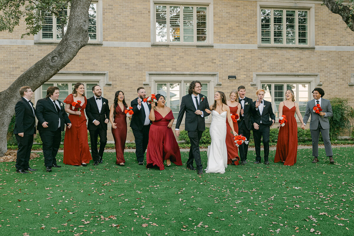 Full bridal party gathered for editorial-style group photo outside elegant San Antonio venue