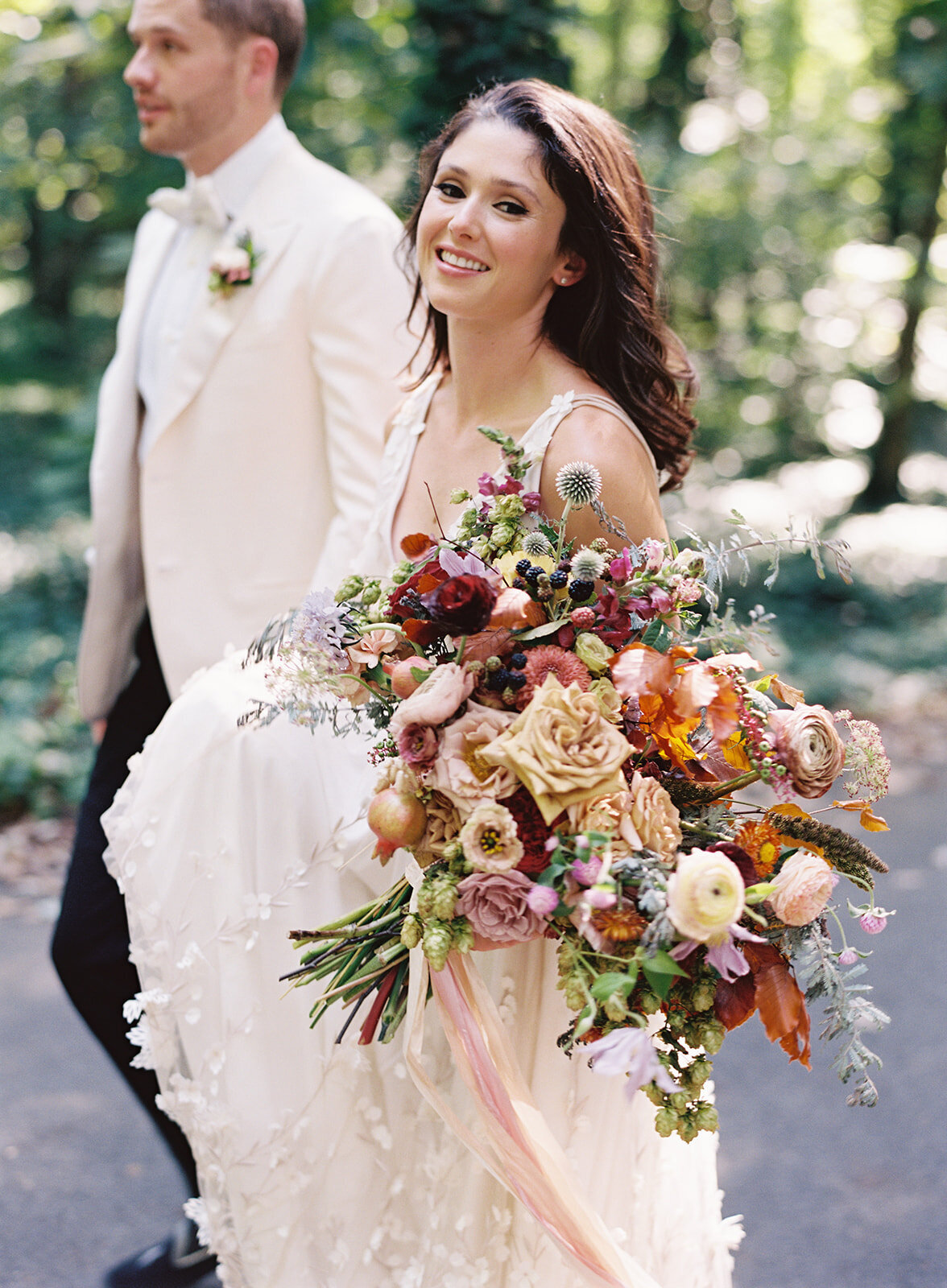 Lush, untamed bridal bouquet with garden roses, wildflowers, hops, blackberries, fruiting branches, ranunculus, copper beech, and natural greenery. Early fall RT Lodge wedding floral design by Rosemary & Finch, Nashville based florist.