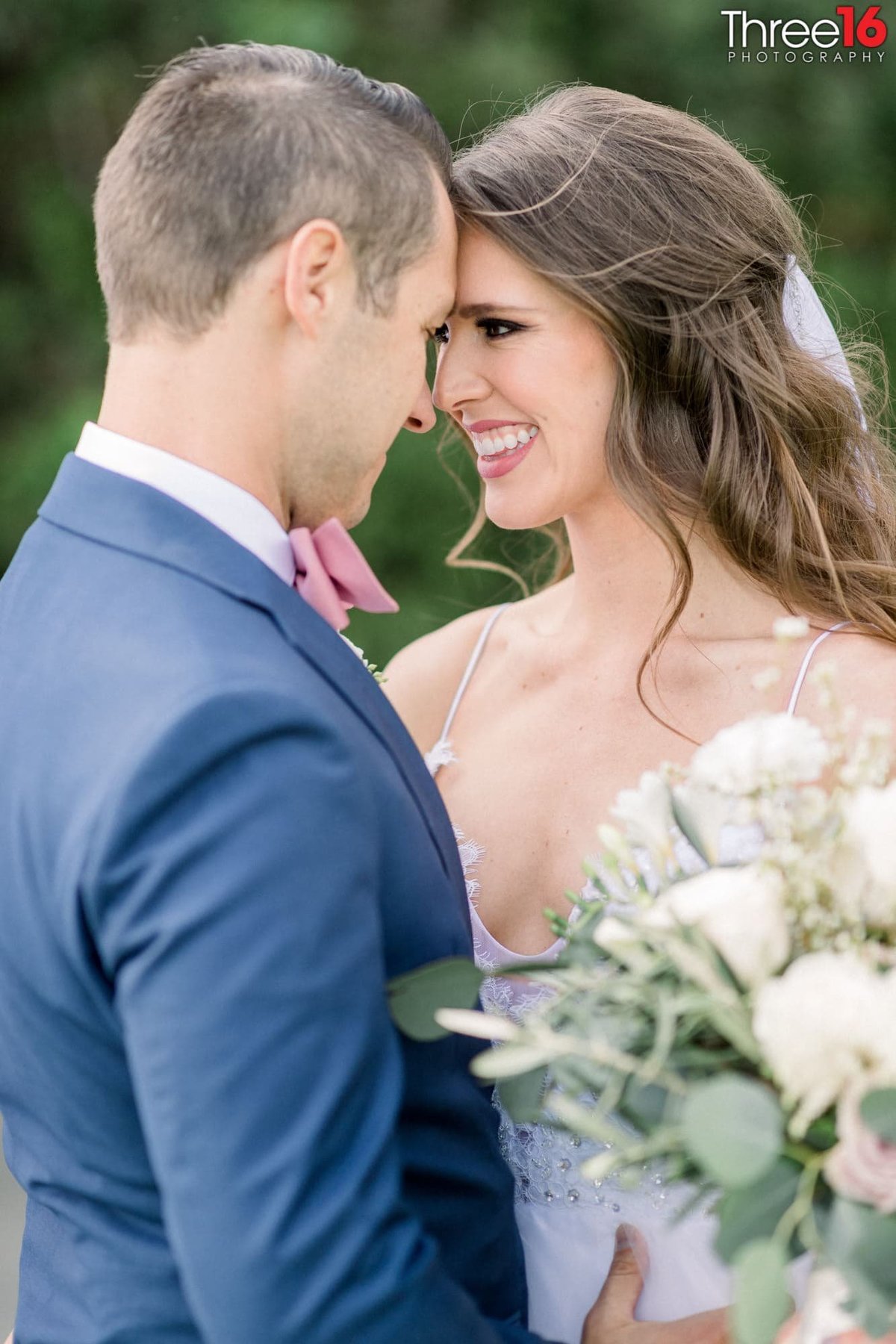 Newly married couple share a tender moment as the Bride is all smiles