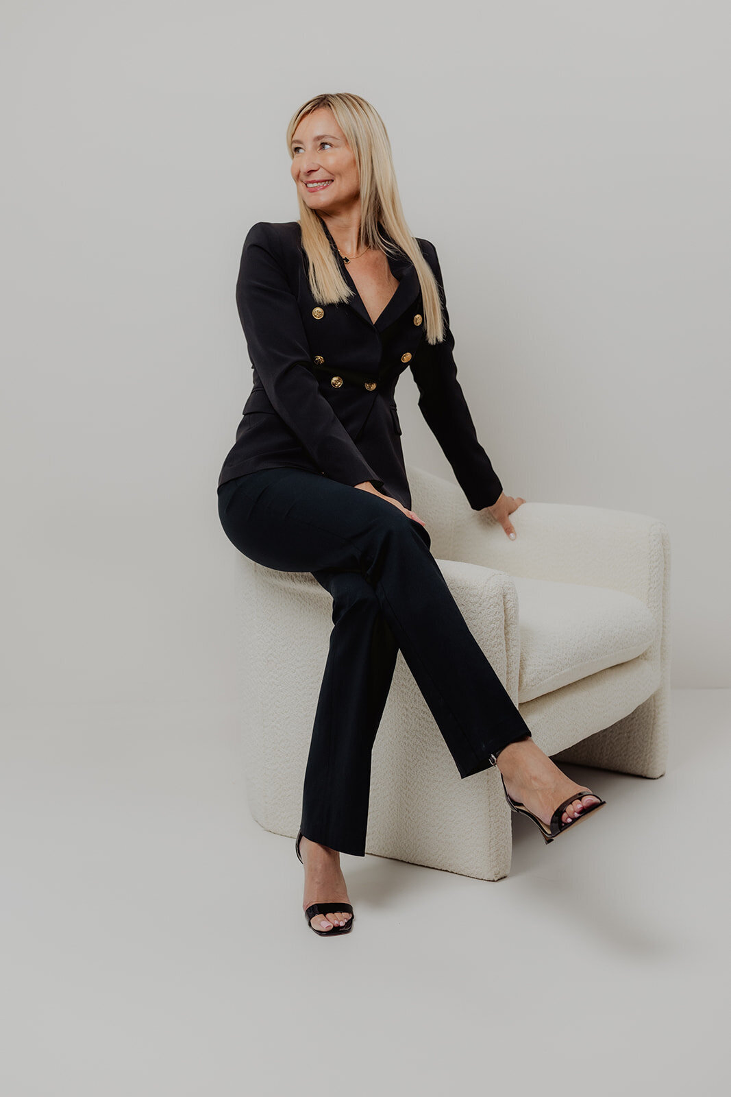 professional portrait of a woman in black power suit