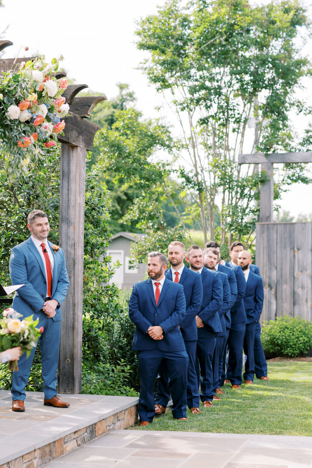 Groom and groomsmen in front of wedding altar