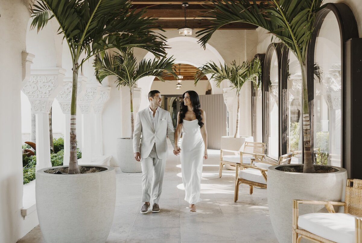 newly wed couple holds hands after wedding ceremony in south florida