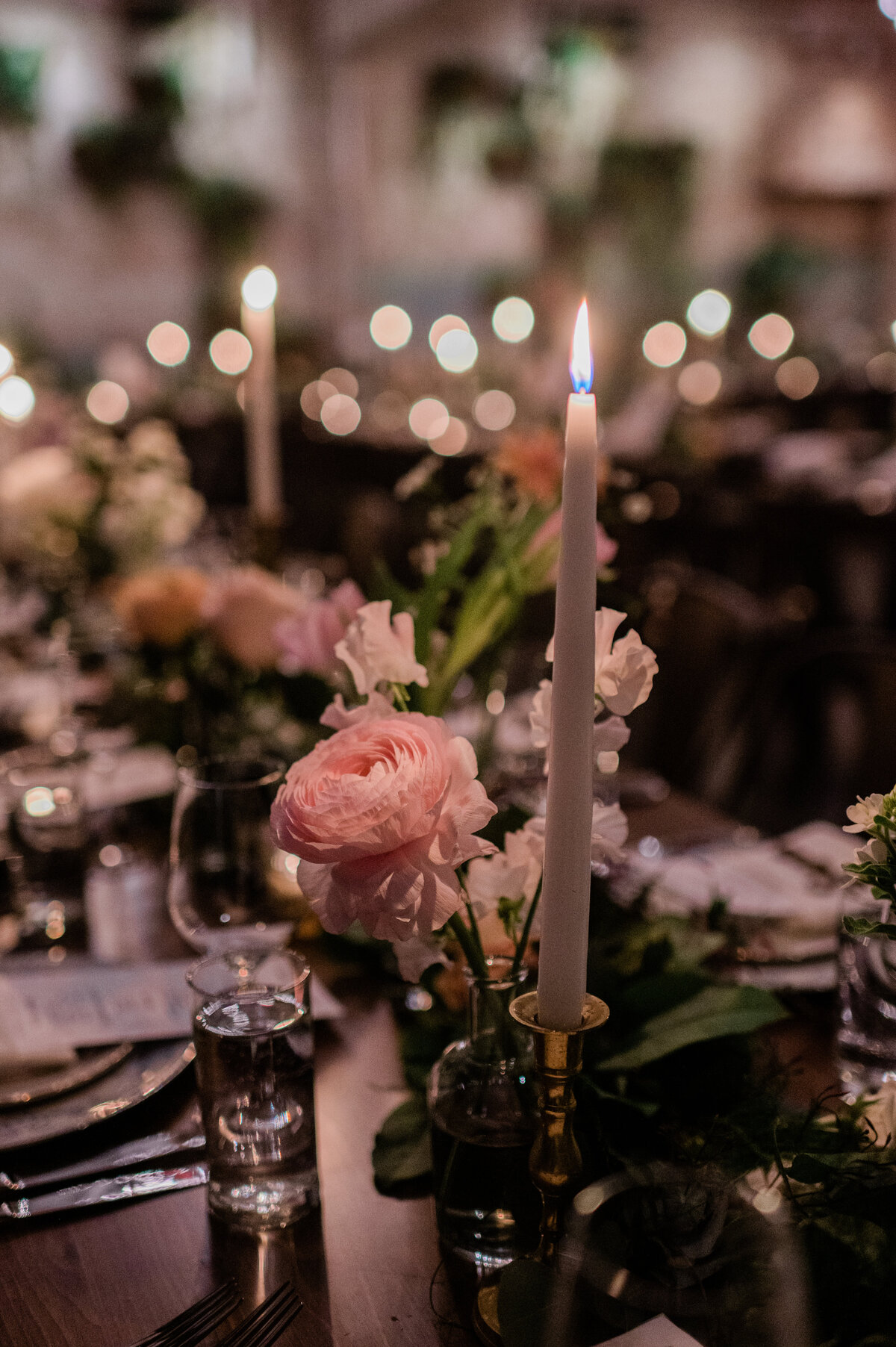 Floral and candle lit centerpieces on a reception table 