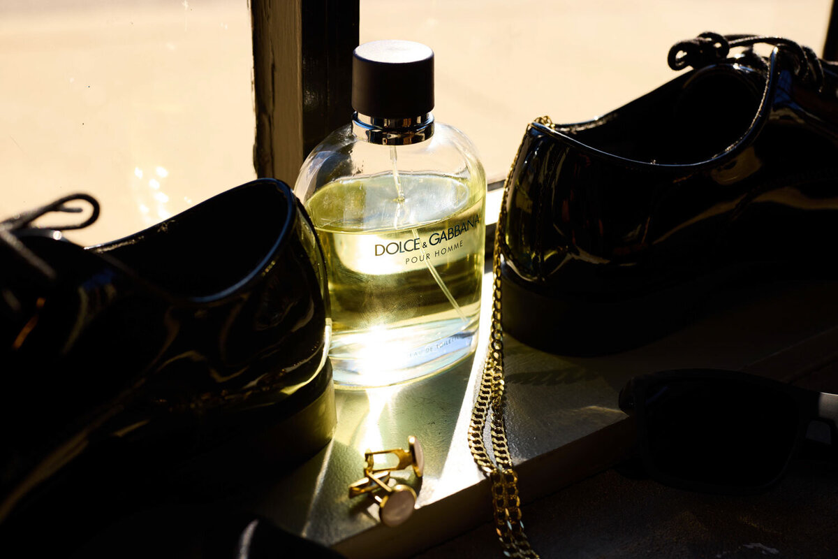 Flat lay of perfume and other wedding accessories of the couple 