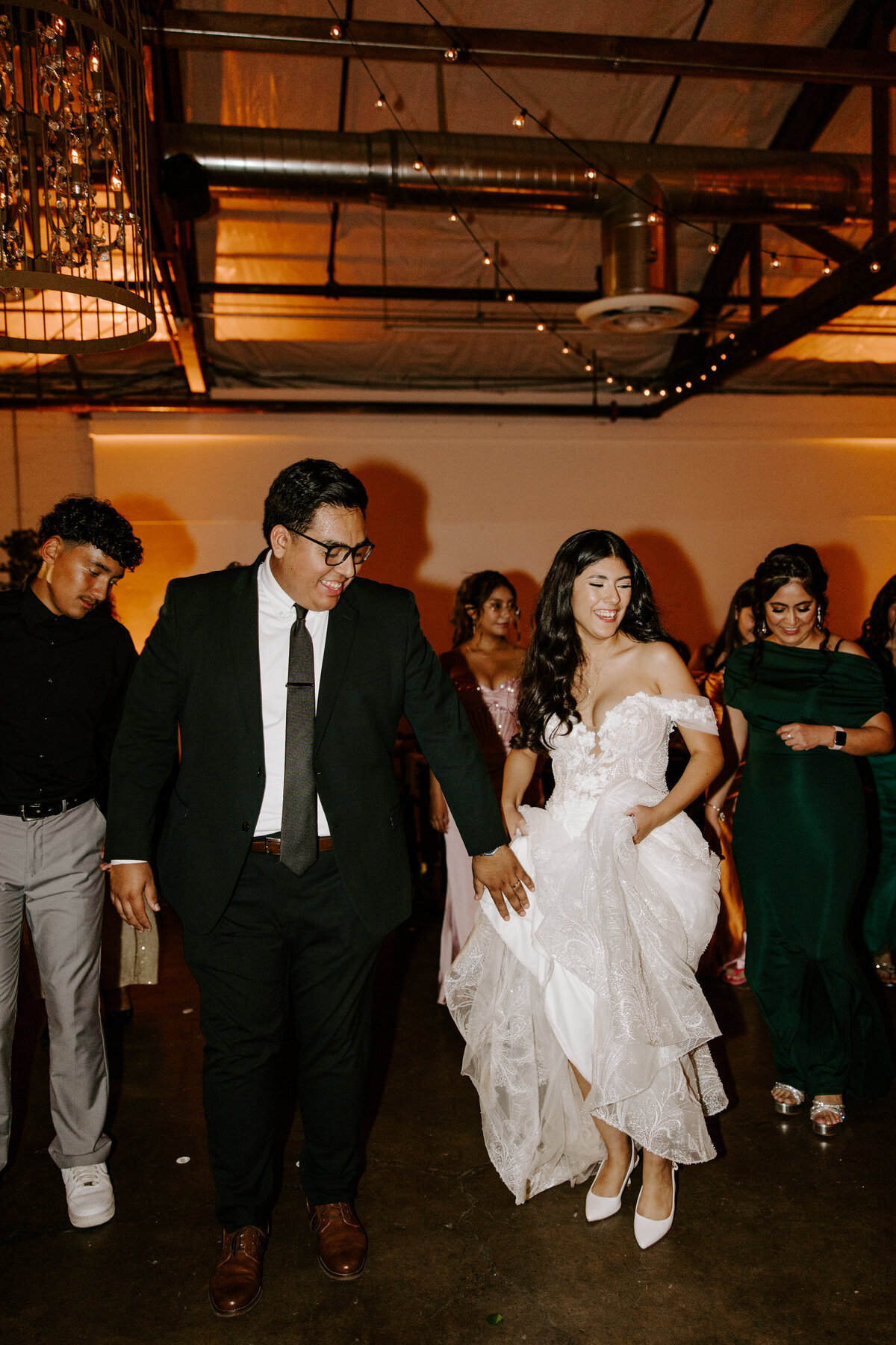 A couple parties on the dance floor during their reception.