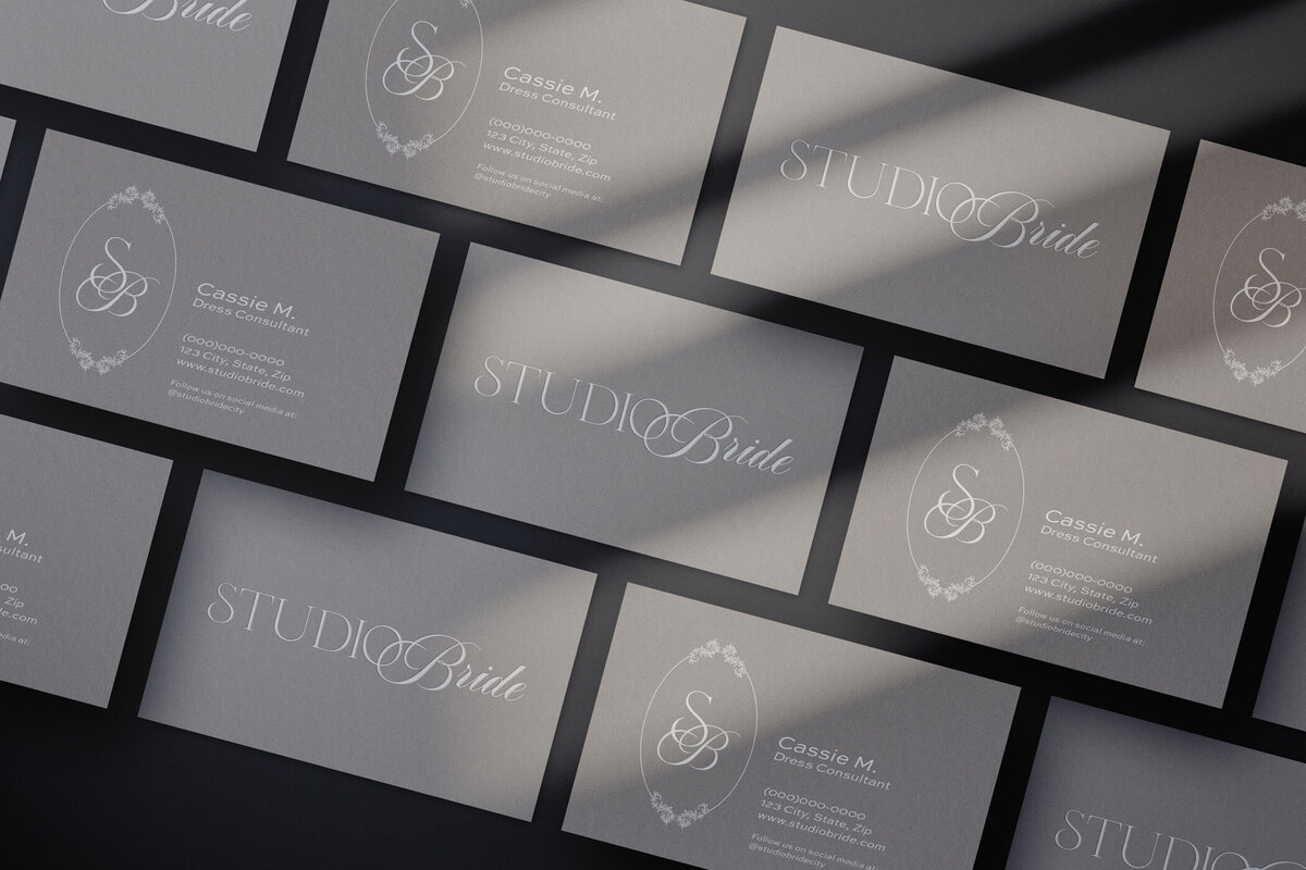 Cream color business cards for a bridal salon named Studio Bride with a logo and brandmark, as well as the bridal consultant's name and contact information.